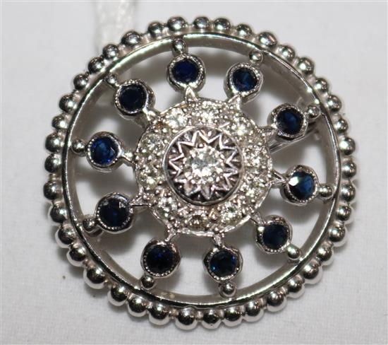 A 1970s platinum and gem set circular brooch, 1in.